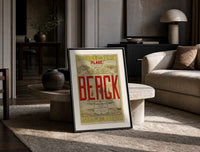 Berck beach seaside resort advertisement print in a black frame leaning on a travertine table in a sunlit lounge