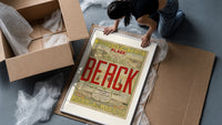 Berck beach seaside resort advertisement framed print being unpacked from protective bubble wrap and a box