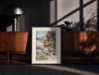 Black-framed woman rowing boat on lake print on a moody console with designer coffee-table books