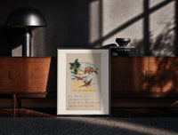 Black-framed Birds on branch with holly print on a moody console with designer coffee-table books