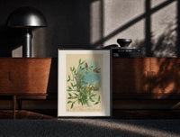 Black-framed Birds Wishing You a Merry Christmas print on the floor in front of a dark wooden console