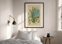 Birds Wishing You a Merry Christmas print in a black frame above a bed with striped linens