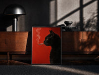 Black-framed Black Cat Smoking a Cigarette print on the floor in front of a dark wooden console