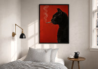 Black Cat Smoking a Cigarette print in a black frame above a bed with striped linens, a brass wall lamp and a sunlit window