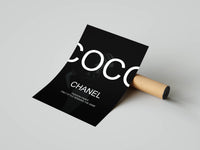 Black Coco Chanel fashion quote poster partially unrolled from a brown cardboard shipping tube