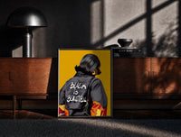 Black-framed Black Is Beautiful Flame Jacket print on the floor in front of a dark wooden console