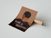 Gently curled Black Is Beautiful Jacket print beside its protective shipping tube