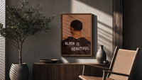 Black Is Beautiful Jacket poster framed above a fluted sideboard beside a potted tree