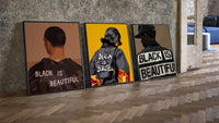 Black Is Beautiful Set of 3 leaning on parquet beside a vintage loft door