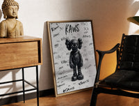 Brass-framed Black KAWS Companion figure standing print leaning in a warm styled corner by a sculpture