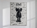 Black KAWS Companion figure standing poster in a slim frame on a bright wall with soft window light