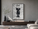 Black KAWS Companion figure standing poster framed above a wood console in a concrete-wall living room