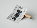 Rolled Black KAWS Companion figure standing poster beside its crush-resistant kraft shipping tube