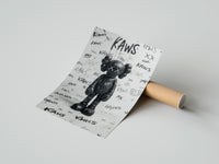 Rolled Black KAWS Companion figure standing poster beside its crush-resistant kraft shipping tube