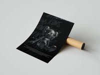 Dynamic black KAWS companion on dark graffiti background, print unrolled beside a cardboard tube on a gray surface