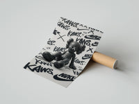 Rolled Black KAWS Companion figure sitting poster beside its crush-resistant kraft shipping tube