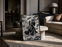Black KAWS Companion figure sitting print in a black frame leaning on a travertine table in a sunlit lounge