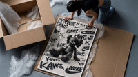 Black KAWS Companion figure sitting framed print being unpacked from protective bubble wrap and a box