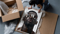 Black Man in Metallic Sunglasses framed print being unpacked from protective bubble wrap and a box