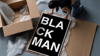 Black Man Lettering framed print being unpacked from protective bubble wrap and a box
