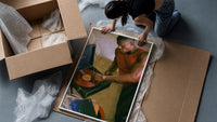 Black Man Playing a Vinyl Record framed print being unpacked from protective bubble wrap and a box