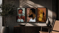 Black Man Reading and Grooming Set of 3 in walnut frames above a sideboard in a warm room