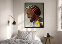 Black Man with Colorful Hair Clips print in a black frame above a bed with striped linens