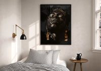 Black Man with Gold Drop Earrings print in a black frame above a bed with striped linens