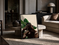 Black Man with Hand on Head print on the floor, leaning against a travertine table