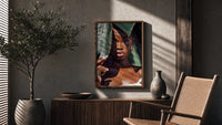 Black Woman with Tropical Leaves poster framed above a fluted sideboard beside a potted tree