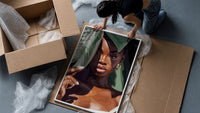 Black Woman with Tropical Leaves framed print being unpacked from protective bubble wrap and a box