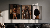 Black Woman Hairstyles Set of 3 in black frames on a grey wall above a leather sofa