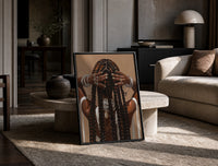 Black Woman Holding Her Braids print on the floor, leaning against a travertine table