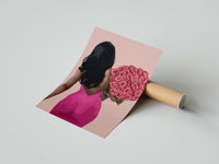 Gently curled Black Woman Holding Pink Roses print beside its protective shipping tube