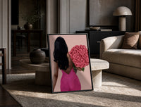 Black Woman Holding Pink Roses print on the floor, leaning against a travertine table