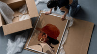 Black Woman in Red Baseball Cap framed print being unpacked from protective bubble wrap and a box