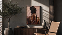 Black Woman with a Braided Bun poster framed above a fluted sideboard beside a potted tree