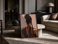 Black Woman with a Braided Bun print on the floor, leaning against a travertine table
