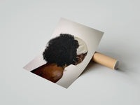Gently curled Black Woman with a Curly Puff print beside its protective shipping tube