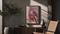 Black Woman with a Pink Headscarf poster framed above a fluted sideboard beside a potted tree