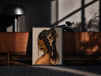 Black-framed Black Woman with Beaded Braids print on the floor in front of a dark wooden console