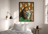 Black Woman with Cash print in a black frame above a bed with striped linens, a brass wall lamp and a sunlit window