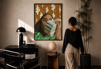 Black Woman with Cash print in a black frame on a sunlit plaster wall, a woman looking on beside a mushroom lamp