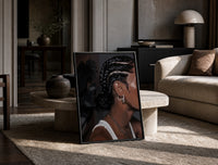Black Woman with Cornrow Braids print on the floor, leaning against a travertine table