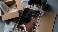 Black Woman with Cornrow Braids framed print being unpacked from protective bubble wrap and a box