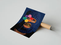 Gently curled Blue Ski Mask with a Flower print beside its protective shipping tube