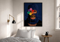 Blue Ski Mask with a Flower print in a black frame above a bed with striped linens, a brass wall lamp and a sunlit window