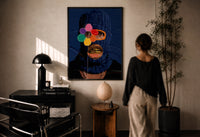 Blue Ski Mask with a Flower print in a black frame on a sunlit plaster wall, a woman looking on beside a mushroom lamp