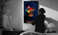 Blue Ski Mask with a Flower print in a slim black frame being hung on a sunlit wall in a monochrome room