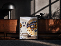 Black-framed Blueberry Banana Oatmeal Bowl print on the floor in front of a dark wooden console